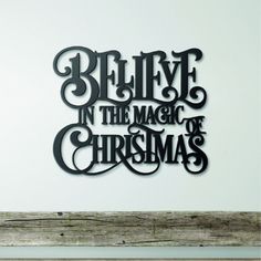 a metal sign that says believe in the magic of christmas