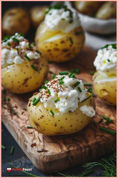 baked potatoes with cream cheese and chives on a cutting board next to other potatoes