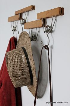 a hat hanging from hooks on a wall