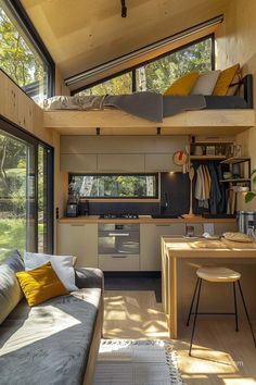 a living room filled with furniture next to a kitchen and dining area under a roof