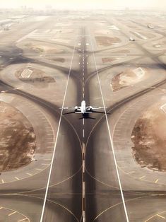 an airplane is flying low over the runways in this aerial photo taken from above