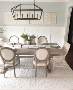 a dining room table with chairs and a chandelier