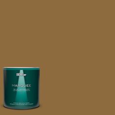 a can of behr marquee paint on a green background