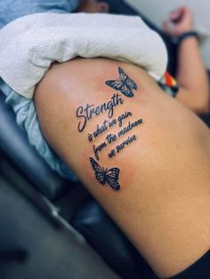 a woman with a butterfly tattoo on her arm and the words strength is what we gain from the mother in mine