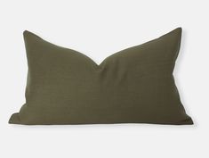 an olive green pillow on a white background