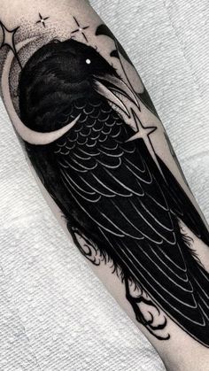 a black and white tattoo with a bird on it's arm