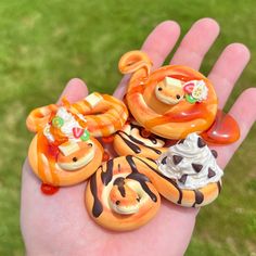 a hand is holding several small animal figurines