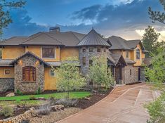 a large house with stone and wood accents