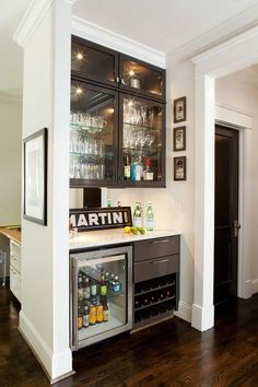 a home bar with wine glasses and liquor bottles