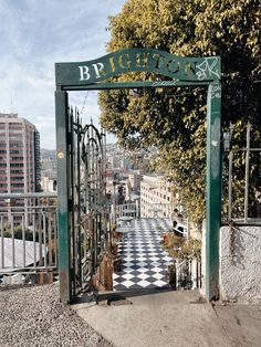 an iron gate leading to a black and white checkered floor