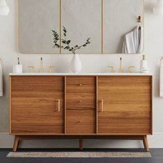 a bathroom vanity with two mirrors above it