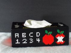 a tissue box with an apple on it and the words abcd 1234 printed on it