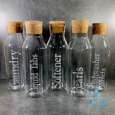 three empty glass bottles with cork tops