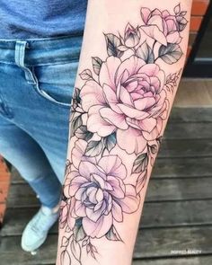 a woman's arm with flowers on it