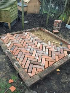 a brick patio being built in the yard with bricks laid out on top of it