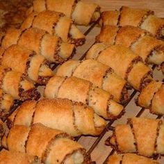 many pastries are lined up on a rack and ready to be baked in the oven