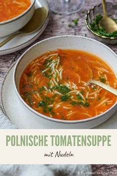 a bowl of soup with noodles and parsley in it on top of a table