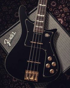 an electric guitar sitting on top of a amp