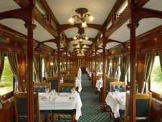 a dining car on a train with tables and chairs