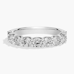 a white gold wedding ring with five stones on the side and four rows of diamonds