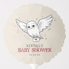 a white round balloon with an owl on it's back and the words kendall's baby shower written in pink