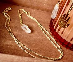 This beautiful gold quartz crystal necklace is perfect for those who love minimalist, natural jewelry with a touch of elegance. Featuring a raw clear quartz stone delicately wrapped in a gold wire and suspended on a dainty gold chain, this necklace brings healing energies and a refined aesthetic to any outfit. Clear quartz is known for its powerful healing properties, promoting clarity, balance, and energy. Whether you're looking to enhance your spiritual practice or elevate your style, this crystal necklace is a must-have. Ideal for gifting or for treating yourself, this piece is versatile and timeless. It can be layered with other necklaces or worn on its own for a subtle statement. *Stone: Raw clear quartz crystal *Chain: Gold-plated, adjustable length (please specify your preferred len Raw Clear Quartz, Dainty Gold Chain, Refined Aesthetic, Raw Crystal Necklace, Natural Jewelry, Jewelry Minimalist, Quartz Crystal Necklace, Healing Crystal Jewelry, Crystal Chain