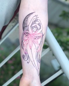 a woman's arm with a tattoo on it and a pink ribbon around the wrist