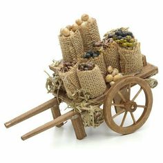 an old wooden wagon filled with lots of nuts and other things on it's wheels