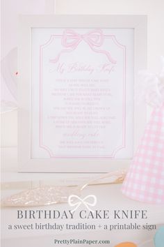 the birthday cake knife is displayed in front of a pink and white frame with an angel on it