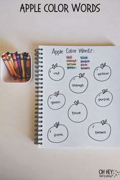 an apple color words worksheet with colored pencils