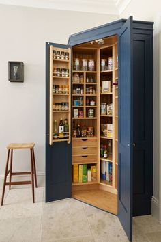 an open pantry in the corner of a room