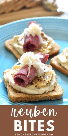 three pieces of bread with cream cheese and meat on them, sitting on a blue plate