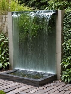 a water fountain in the middle of a garden