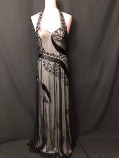 "This beautiful long Black with white lining sleeveless gown is beaded and embroidery design all over in the front and back. This gown has amazing workmanship and looks very elegant. Measurements for this gown are: Size-4                                  Size-6                                                    Chest - 32\"                         Chest-34\"                      Waist - 27\"                          Waist-27\"                        Length - 59\"                       Length-60\ Embellished Evening Ball Gown Maxi Dress, Embellished Ball Gown Maxi Dress For Evening, Formal Gown With Sheer Back And Fitted Bodice, Elegant Gown With Sheer Back And Fitted Bodice, Embellished Ball Gown Maxi Dress For Formal Events, Elegant Gown With Sheer Bodice, Elegant Full-length Gown With Sheer Bodice, Evening Gown With Sheer Back, Evening Gown With Sheer Back Floor-length