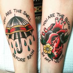 two people with tattoos on their legs that say you are the smell before rain and umbrella