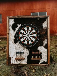 a dart board with darts in it on the grass