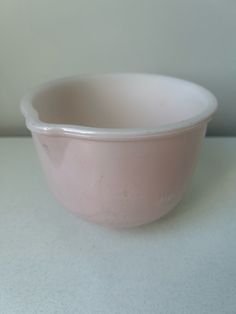 a pink bowl sitting on top of a white counter