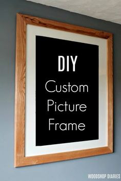 a black and white frame hanging on the wall above a wooden framed sign that says diy custom picture frame