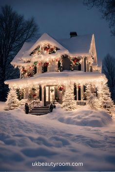 a house covered in christmas lights and garlands with snow on the front lawn,