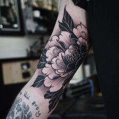 a person with a flower tattoo on their arm