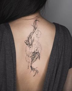 the back of a woman's neck with a tattoo on it