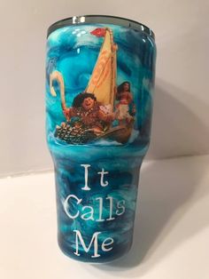 a blue glass with the words it calls me painted on it and an image of two people in a boat