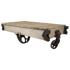 an old wooden table with wheels on the bottom and one wheel attached to it's sides