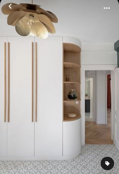 a room with white cabinets and a ceiling fan hanging from the ceiling over it's head