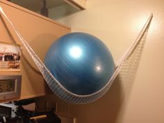 an exercise ball in a hammock hanging from the ceiling