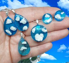 A beautiful jewelry set of sky and clouds in the shape of a teardrop or circle with silverplated backings or necklace chain! Its made with very fluffy clouds set in blue resin. The sky can be customize to a different color also to represent the sunset or a color you like.  It takes a couple of days to make and then is shipped out on the next business day. Thank you and send me a message if you have any questions. Handmade Resin Teardrop Jewelry, Handmade Drop Resin Jewelry, Blue Teardrop Resin Jewelry, Celestial Resin Jewelry As Gift, Celestial Resin Jewelry For Gifts, Celestial Resin Jewelry As A Gift, Celestial Style Resin Jewelry For Gifts, Handmade Celestial Resin Jewelry, Blue Celestial Hypoallergenic Jewelry