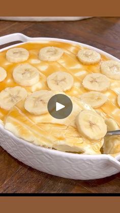 banana pudding in a white casserole dish on a wooden table