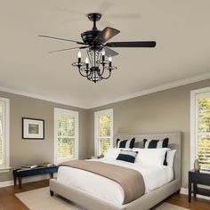 a bed room with a neatly made bed and a ceiling fan