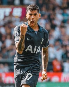 a soccer player with his mouth wide open in front of the crowd at a sporting event