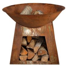 a large metal bowl filled with firewood